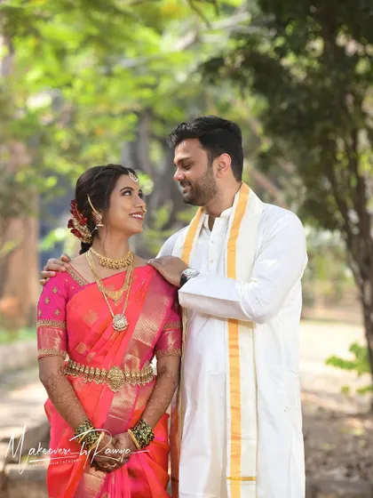 A sweet, candid moment between the couple. Santhoshi's makeup was designed to be long-lasting and photograph beautifully in natural outdoor lighting.