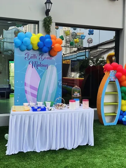 A 'Bath Bomb Making' station at a pool party, a creative and fun activity for the kids.