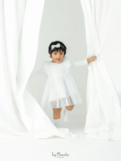Peek-a-boo! A child's portrait session should be as playful as they are. Using simple props like these white curtains, I create a fun environment for your little one's personality to emerge naturally.