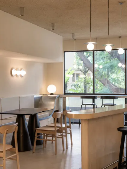 The material palette of beige, black, and wood creates a sophisticated and calming environment.