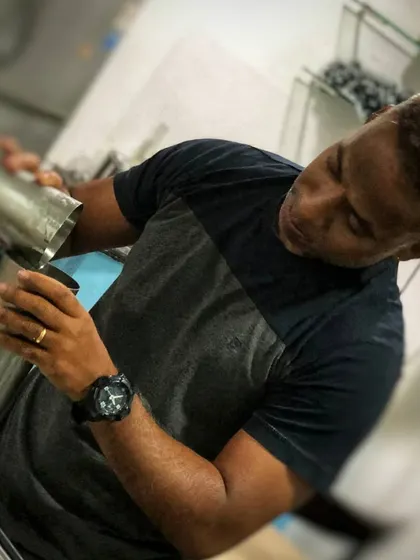 The art of the pour. Here I am carefully straining a freshly shaken cocktail from the shaker into a glass, a crucial step in creating a smooth, perfectly textured drink.