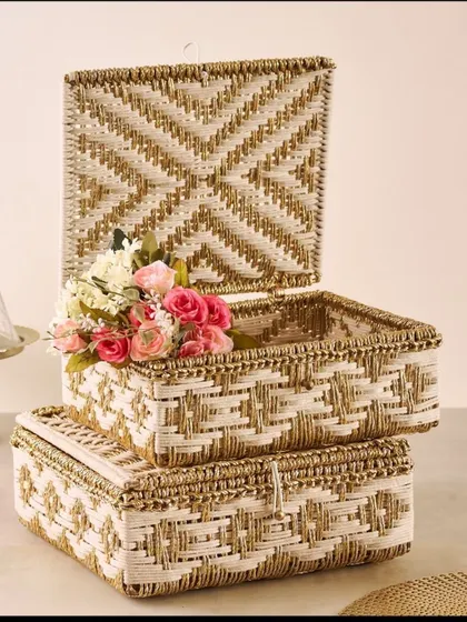 These stacked woven boxes offer a stylish and practical solution for trousseau packing. The intricate white and gold weave gives them a luxurious feel, perfect for storing and presenting wedding gifts.