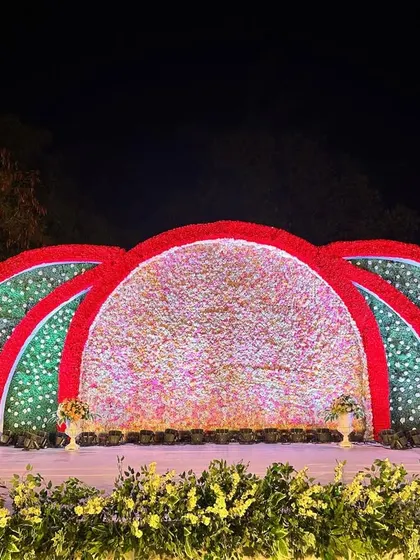 A slightly different angle of the colorful floral arch stage, showing the depth and texture of the flower arrangements.