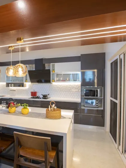 For Mr. Verma's home at Brigade Exotica, I designed this open-concept kitchen with a large breakfast counter. The space is perfect for casual family meals and connects seamlessly with the dining area.