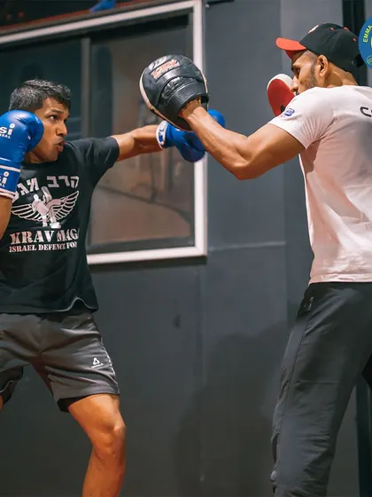 One-on-one coaching is a key part of my program. Here, a coach works with a student on his boxing technique in our unique MMA facility.