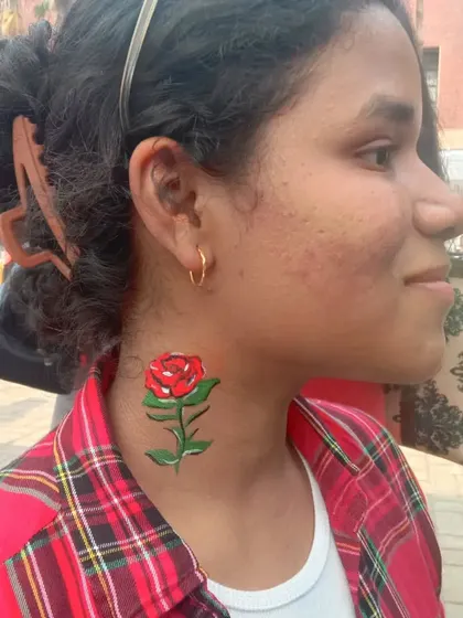 A classic red rose with a green stem painted on the neck. This is a timeless design that works for any occasion.