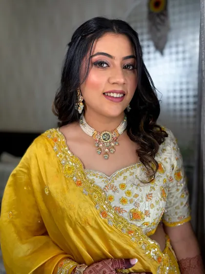 A bright and sunny look for a Haldi or Mehendi ceremony, featuring a yellow and white outfit and fresh, dewy makeup.