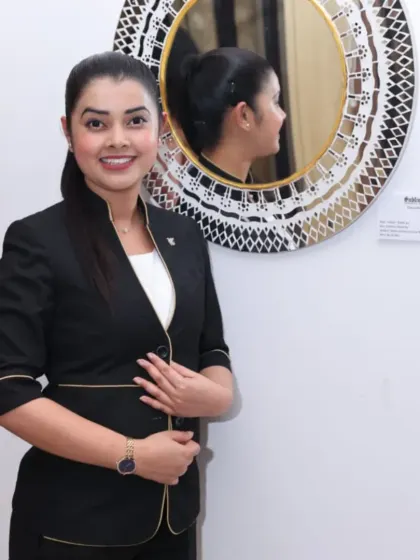 A visitor posing with a mirror artwork at the 'Aaina' exhibition.