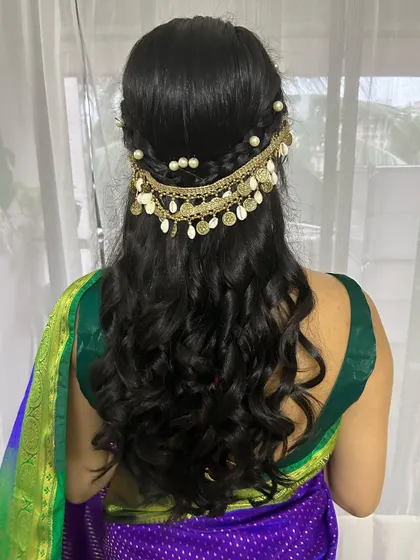 A close-up of the beautiful gold coin and shell hair accessory.