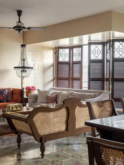 A view across the Calcutta living and dining area. The space is open and flowing, with vintage-inspired furniture and patterned floors that echo the feel of an old Calcutta bungalow.