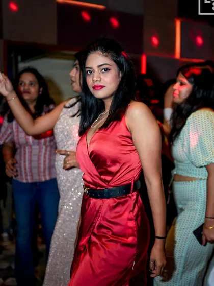 A guest in a stylish red dress, perfectly matching the festive Christmas theme.