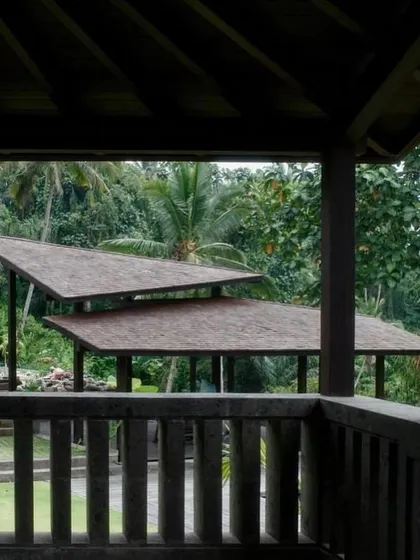 The layered, sloping roofs of pavilions at our Bali project, seen from a balcony. The design draws inspiration from traditional Balinese architecture while maintaining a contemporary feel.