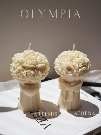 The Artemis and Athena bouquet candles, named after Greek goddesses. One features a heart and the other a bow, adding a touch of symbolism to the beautiful rose bouquets.