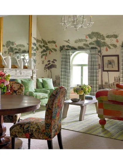 This drawing room is a wonderful example of how to mix and match colours and go bold. The combination of a scenic wallpaper, checked curtains, and floral and patchwork upholstery is whimsical and full of life.