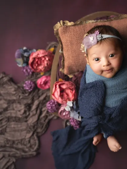 This little one is wide awake and curious. I love capturing these moments of eye contact, showing their budding personality.