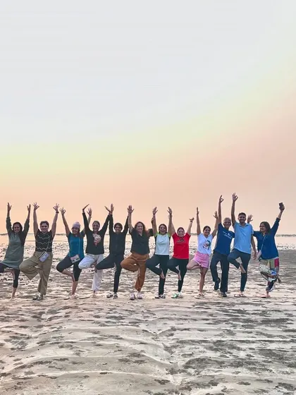 Our retreat group celebrating the sunset with Vrikshasana (Tree Pose) on the beach.