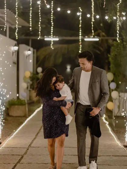 A grand entrance for the family at the golf-themed party, walking down a path lined with sparklers.