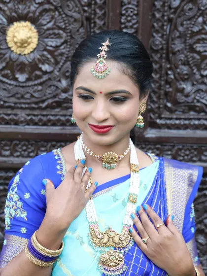 A close-up on the details of her makeup and pearl jewelry. The look is both traditional and sophisticated.