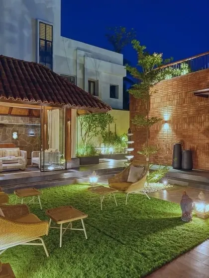 The outdoor seating area at night, illuminated to create a magical and inviting atmosphere for evening gatherings.