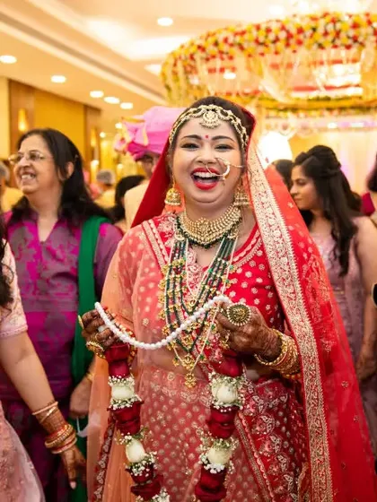 The bride's grand entrance, her face lit up with a huge, infectious laugh as she is greeted by family and friends.