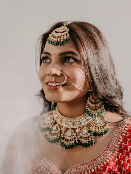 A close-up shot capturing the dreamy, soft-focus light. The makeup details, especially the eye makeup and glowing skin, are highlighted beautifully.