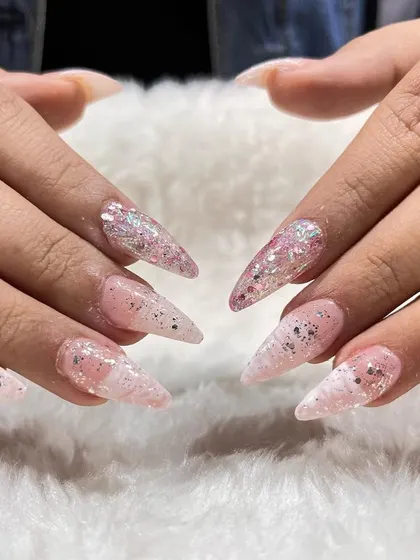 A sharp, stiletto nail set with glitter and inlay effects. We teach various nail shapes and how to create custom designs that cater to every client's style.