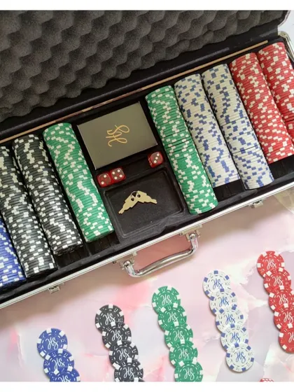 This custom poker set includes personalized chips and a dealer button, all neatly arranged in a professional case. It's a great way to add a personal touch to your game nights.