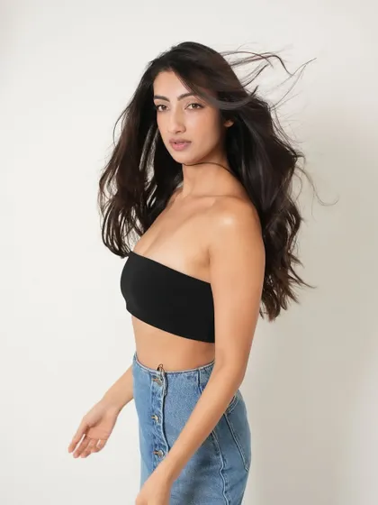 A more casual and modern look from the same shoot. Here, the makeup is stripped back to a fresh, radiant base with a natural lip, showing versatility. The wind-blown hair adds a sense of freedom and energy.