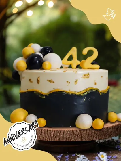 Celebrating 42 wonderful years together. This modern anniversary cake for Mr. and Mrs. Gupta in Kirti Nagar features a chic black and gold design, proving that every year of love is worth celebrating in style.