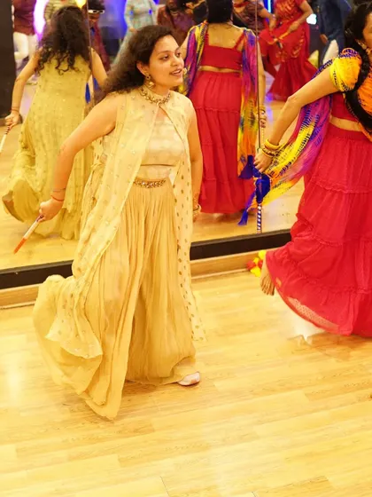 A dancer showing off a graceful twirl during a Garba routine. Our choreography includes beautiful, photo-worthy moments.