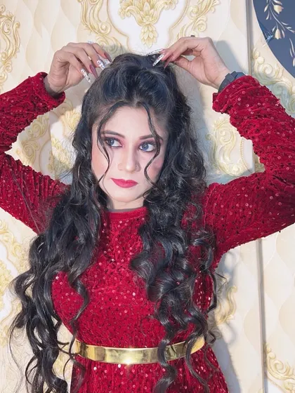 A glamorous look for a night out, featuring a sparkly red top and dramatic makeup. The hair is styled in big, voluminous curls.