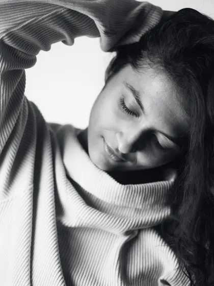 An introspective moment with eyes closed. This close-up in a cozy sweater conveys a sense of peace and self-love, central to the theme of my boudoir photography.