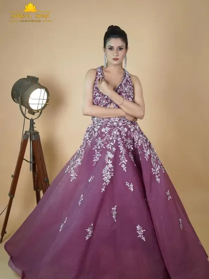 A full-length shot of the magenta gown, showcasing its flowing skirt and the beautiful way the silver embroidery cascades down the fabric.