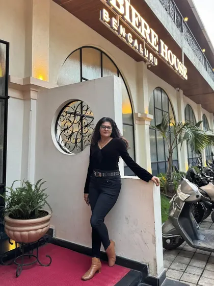 A full view of my casual-chic black outfit, paired with tan boots. This shows how accessories can completely define a look.