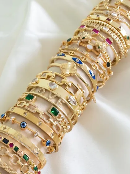 Mix, match, and stack with my wide range of bangles. This flat lay shows the incredible variety I offer, from evil eye to emeralds.