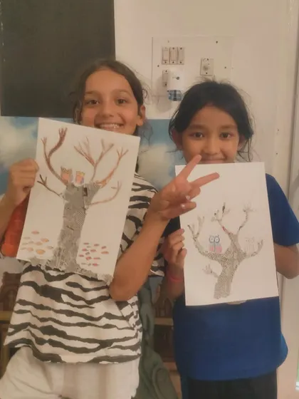 A duplicate image of two friends, our "Crazy Bees," having fun showing off their imaginative tree drawings.