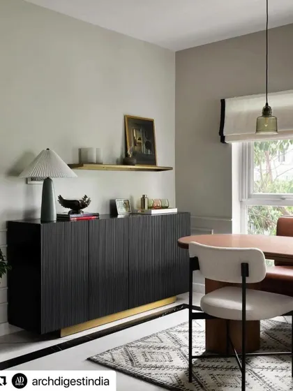 Our black fluted sideboard with a brass base, featured in an Architectural Digest Small Spaces article on a project by Weespaces. The sideboard provides texture and sophisticated storage.