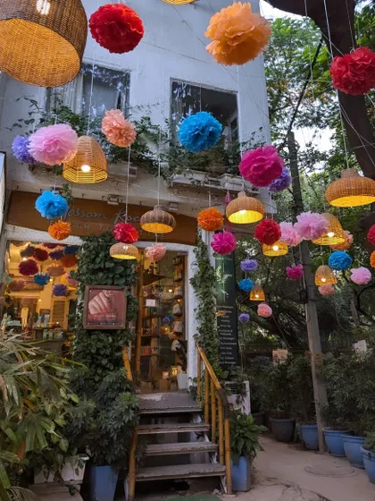 My salon entrance during Diwali, adorned with colorful paper pom-poms and beautiful wicker lamps, creating a vibrant and festive welcome.