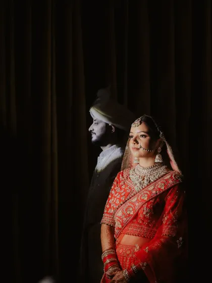 An artistic portrait of Ananta and Divya, where the groom's reflection stands beside his bride. It symbolizes his constant presence and support, even when unseen.