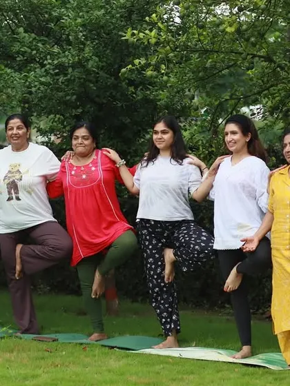 A fun moment with students practicing a supported tree pose together. Community and connection are at the heart of my group yoga classes.