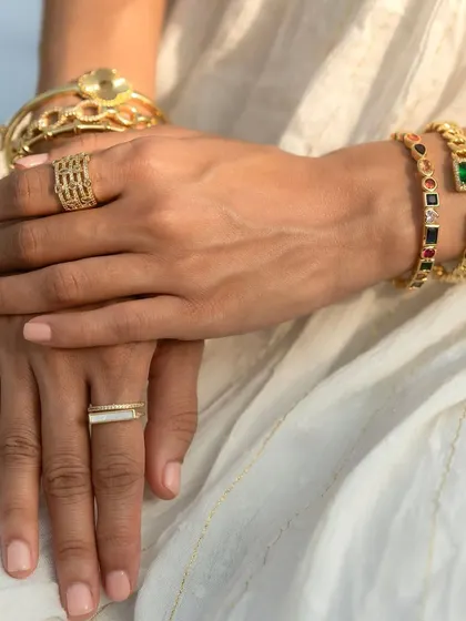 Another angle of the full hand look, with a focus on the multi-colored cuff and emerald loop bangles.