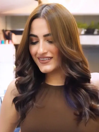 The smile of a client who is in love with her new hair. That's the vibe we create.