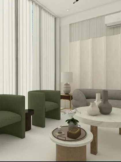 A living room design featuring a mix of curved sofas in grey and green. The nested marble-top coffee tables add a touch of luxury, while the textured wall panels create visual interest.