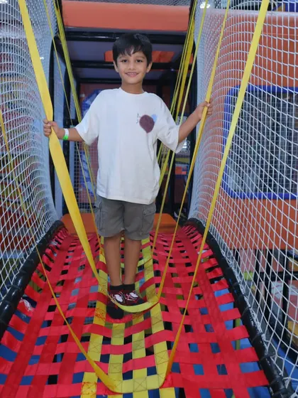 This netted bridge with yellow strap holds is another fun obstacle that helps kids develop balance and coordination.