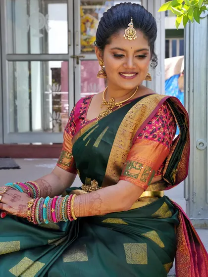 The complete look, with the bride seated. The makeup is balanced to look perfect whether she is standing, sitting, or participating in the wedding rituals.
