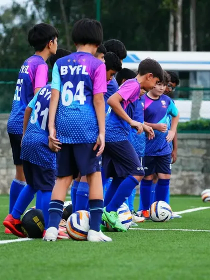 The U13 team huddles up during a training session, listening to instructions and building team chemistry.