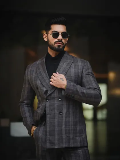 A classic, powerful portrait for a men's fashion portfolio. The focus here is on sharp tailoring and a confident stance, using controlled lighting to create a look that is both timeless and modern.