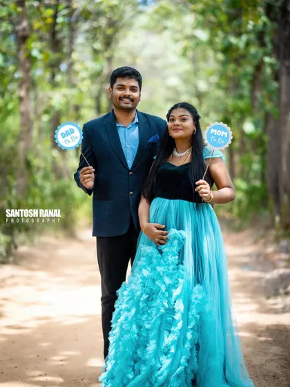 A duplicate of the previous image, highlighting the happy couple as they announce their upcoming roles as parents with cute, personalized props.