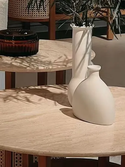 The Siena Coffee and End Tables, with their natural travertine tops, are perfect for holding decor and daily essentials. Their design is inspired by tropical elegance, adding a serene and stylish element to the space.