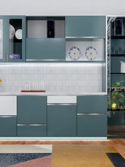 This crockery unit is designed with a teal and white color scheme, featuring glass-paneled doors and integrated lighting. It provides a beautiful and organized way to display fine china and glassware.
